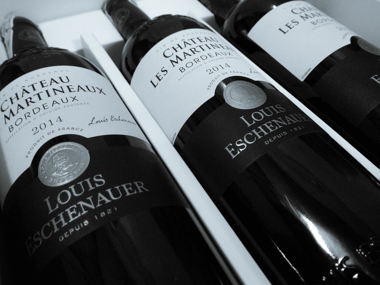 Close-up of Château Martineaux Bordeaux wine bottles highlighting elegance and luxury.